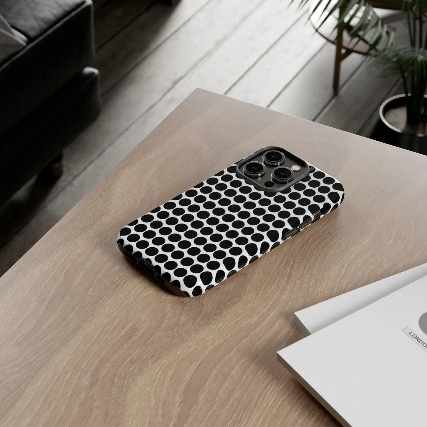 Black white dot pattern tough phone case showing back side with sleek modern design for iphone samsung google
