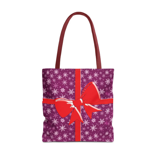 Pink christmas tote bag with purple gift theme, white snowflakes, and red bow design with red handles for festive carryall