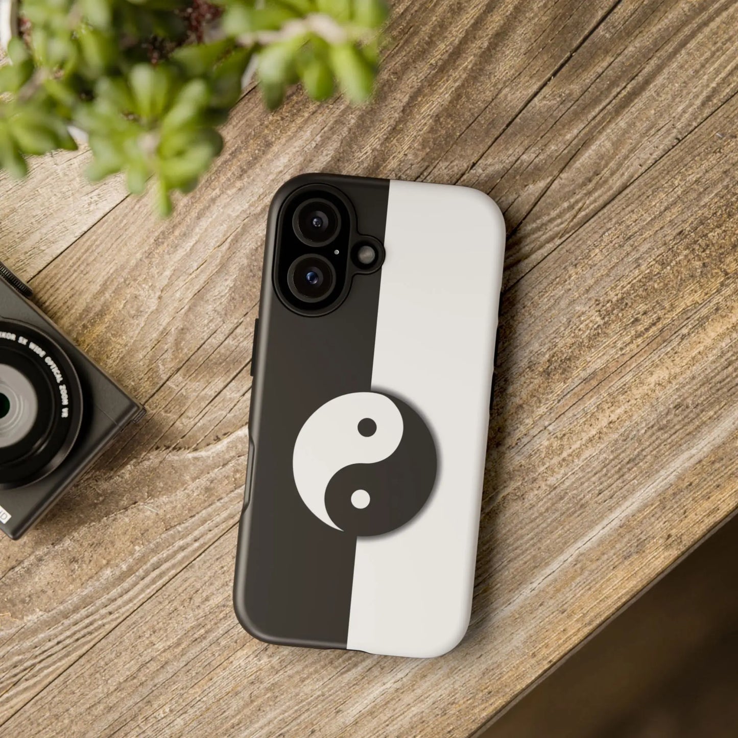 Back side of a tough yin yang black and white phone case featuring a centered yin yang symbol on a split design