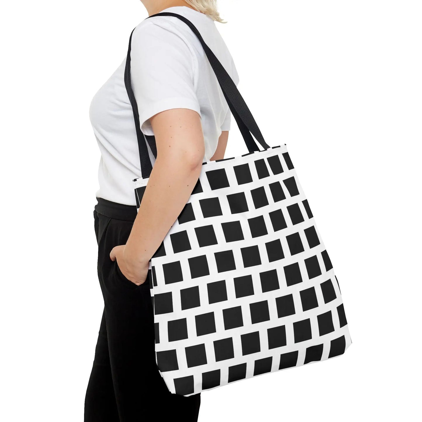 Black and white geometric tote bag with black square pattern and sturdy black straps for versatile use