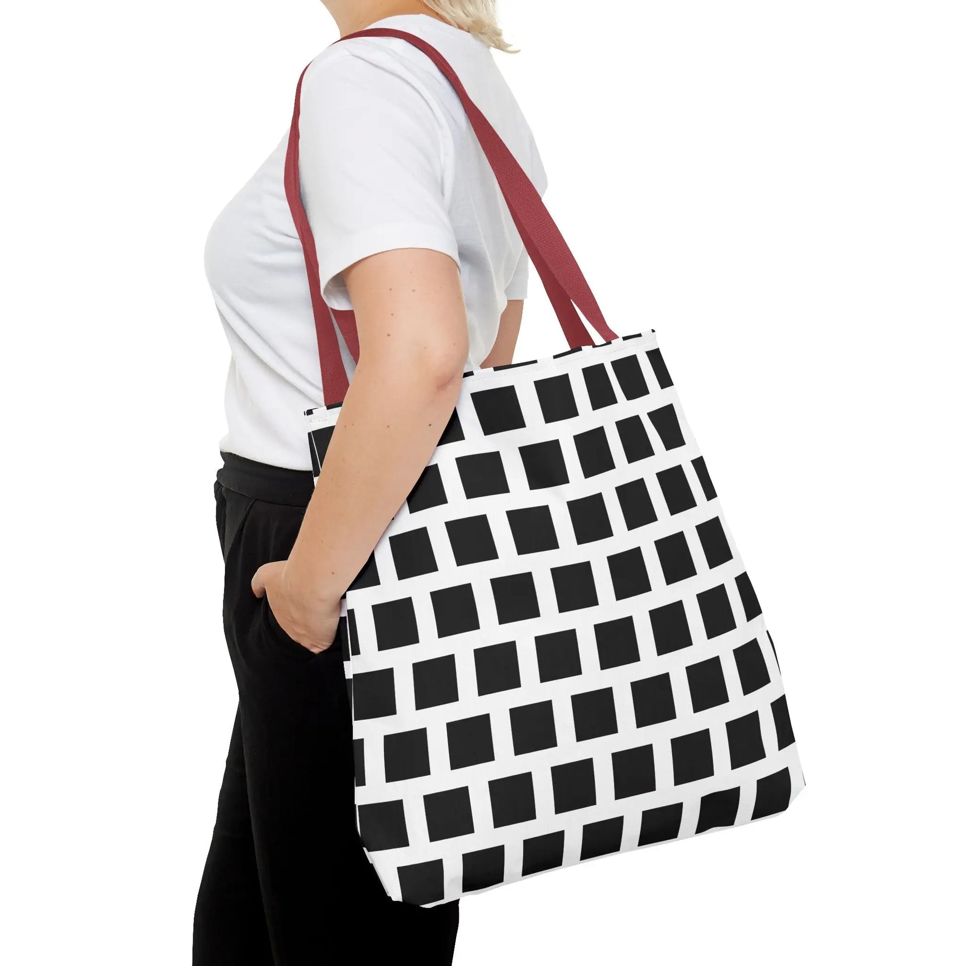 White tote bag with bold black square pattern and maroon fabric handles versatile and durable shoulder bag