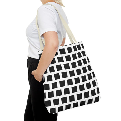 Black and white geometric patterned canvas tote bag with black square pattern and beige shoulder straps for versatile use