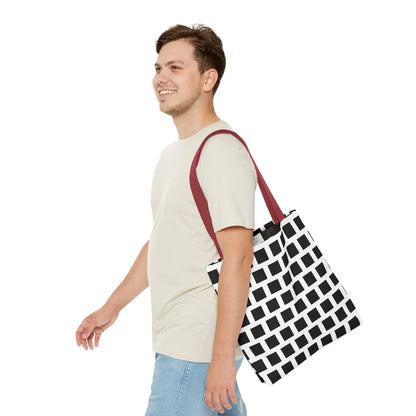 Black and white geometric tote bag with black square pattern and maroon shoulder strap for versatile use