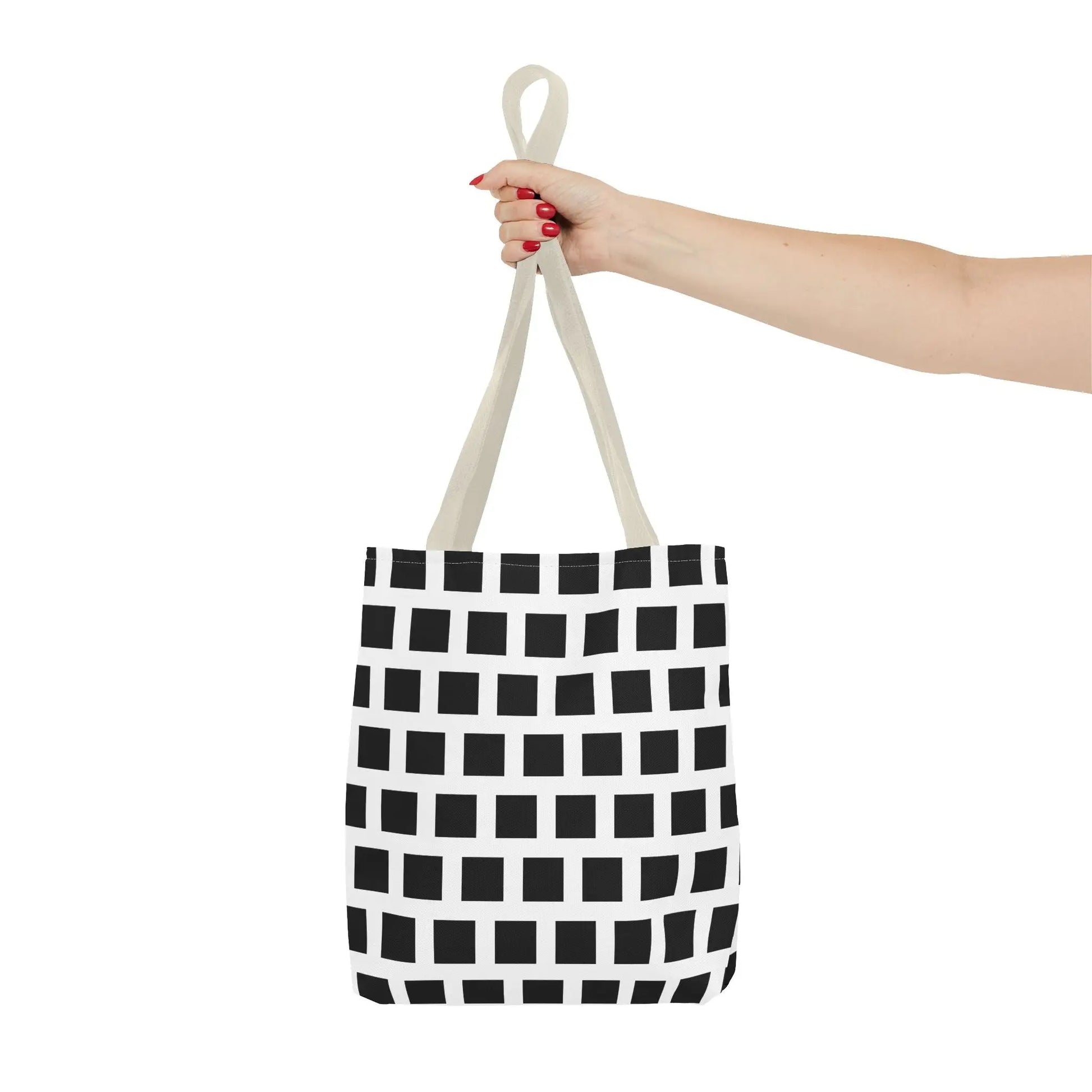 A white canvas tote bag with a black square pattern and beige handles for versatile and durable use