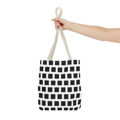 A white canvas tote bag with a black square pattern and beige handles for versatile and durable use