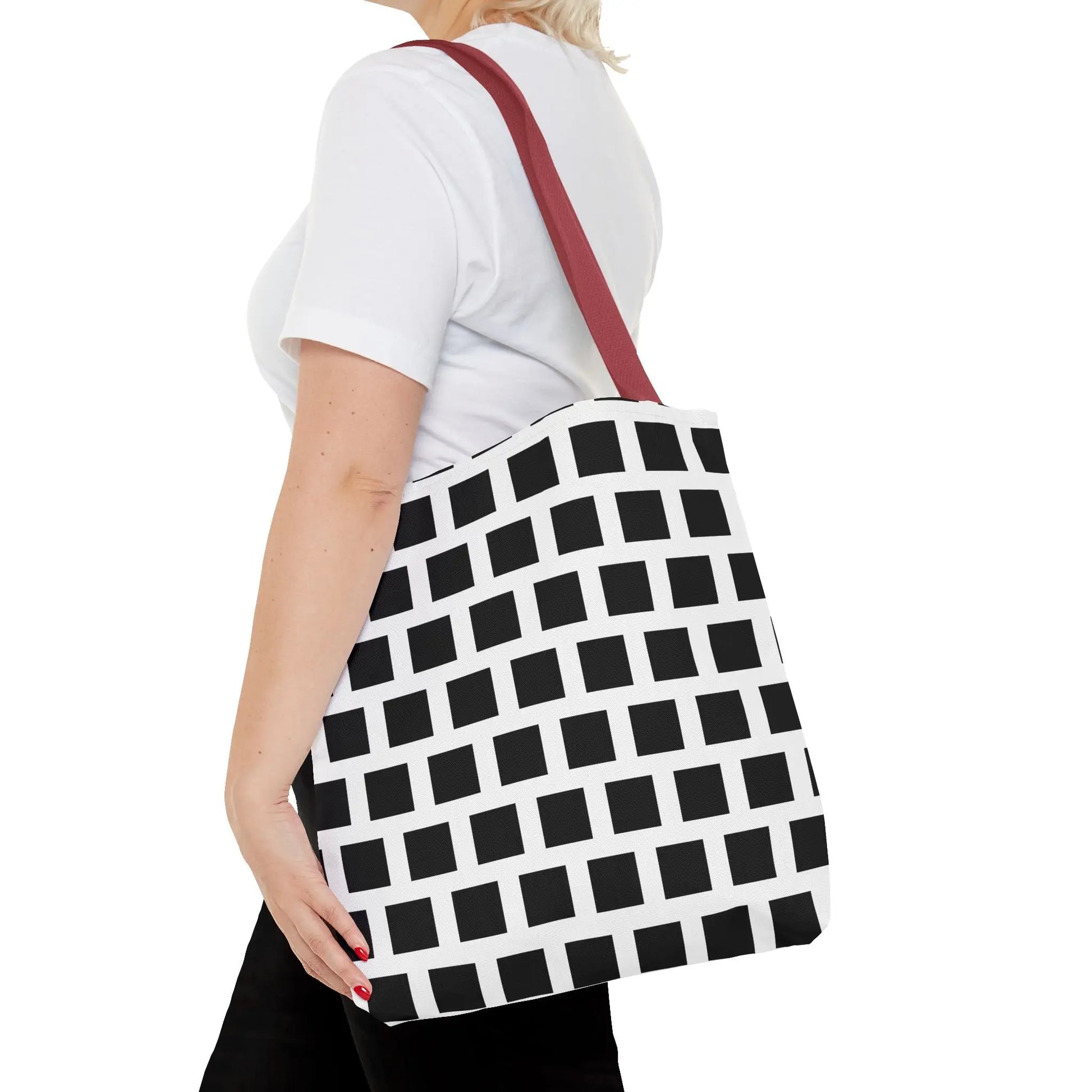 White tote bag with bold black square pattern and red shoulder strap, versatile and durable shoulder bag