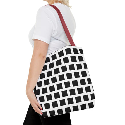 White tote bag with bold black square pattern and red shoulder strap, versatile and durable shoulder bag