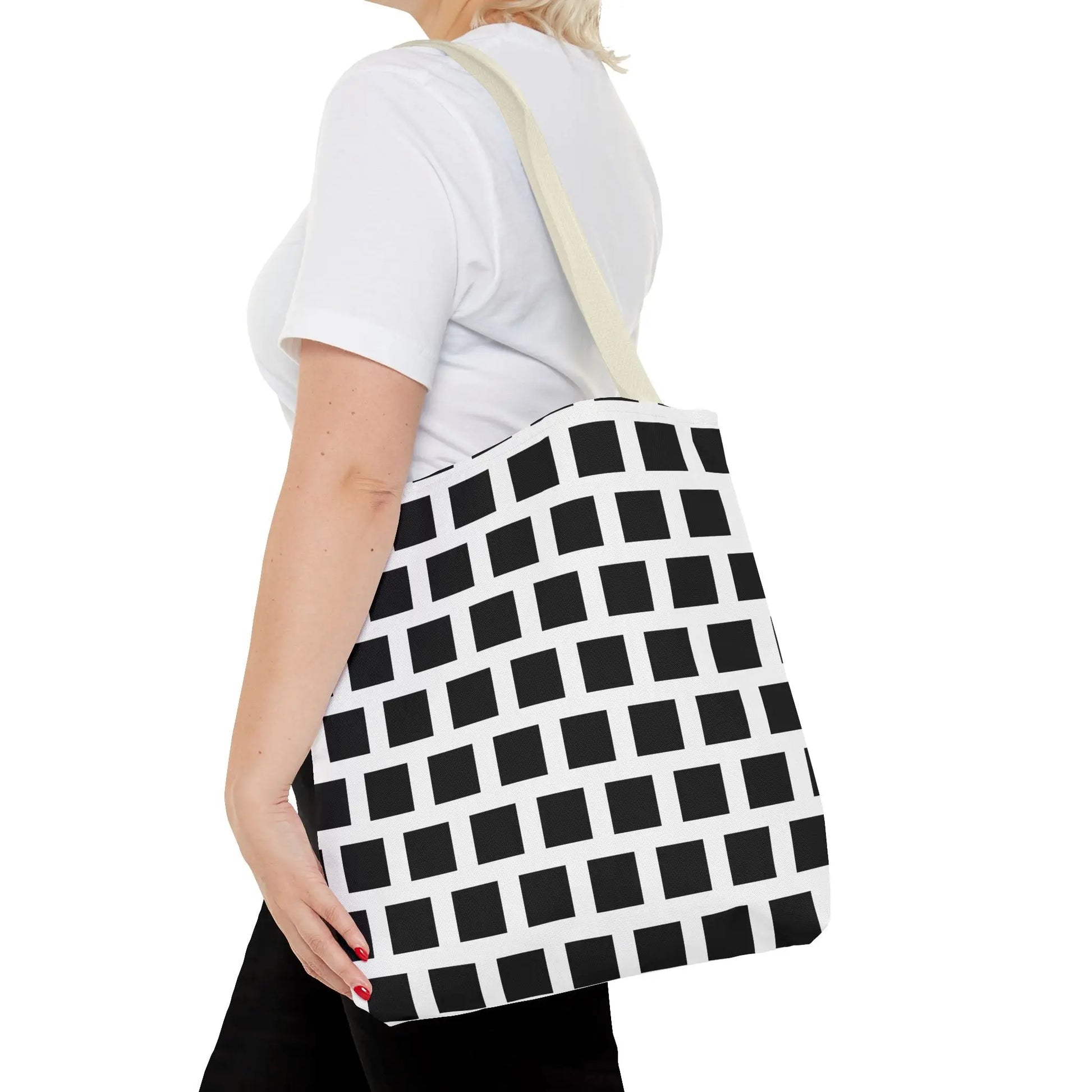 Black and white canvas tote bag with black square pattern and light beige shoulder strap for versatile use