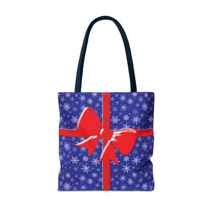 Blue christmas tote bag with white snowflake pattern red bow and black handles perfect for holiday shopping