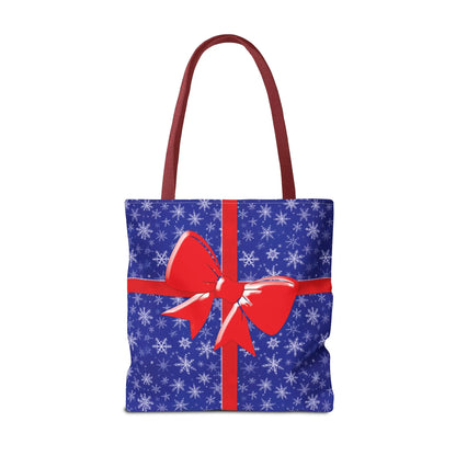 Blue christmas tote bag with white snowflake pattern, red bow design, and matching red handles for holiday shopping