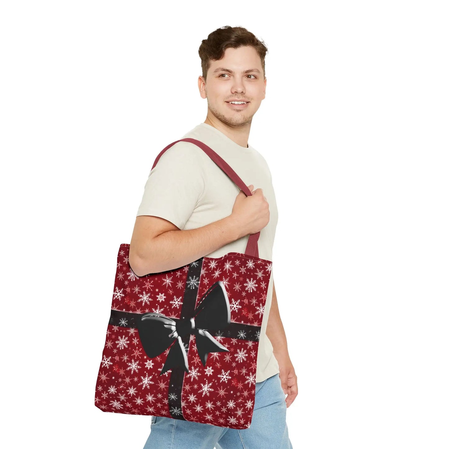 Red holiday tote bag with white snowflake pattern and festive black bow shoulder strap for xmas shopping carryall