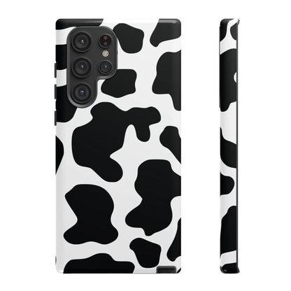 Black cow print phone case with protective cover featuring a black and white cow print pattern on the back side