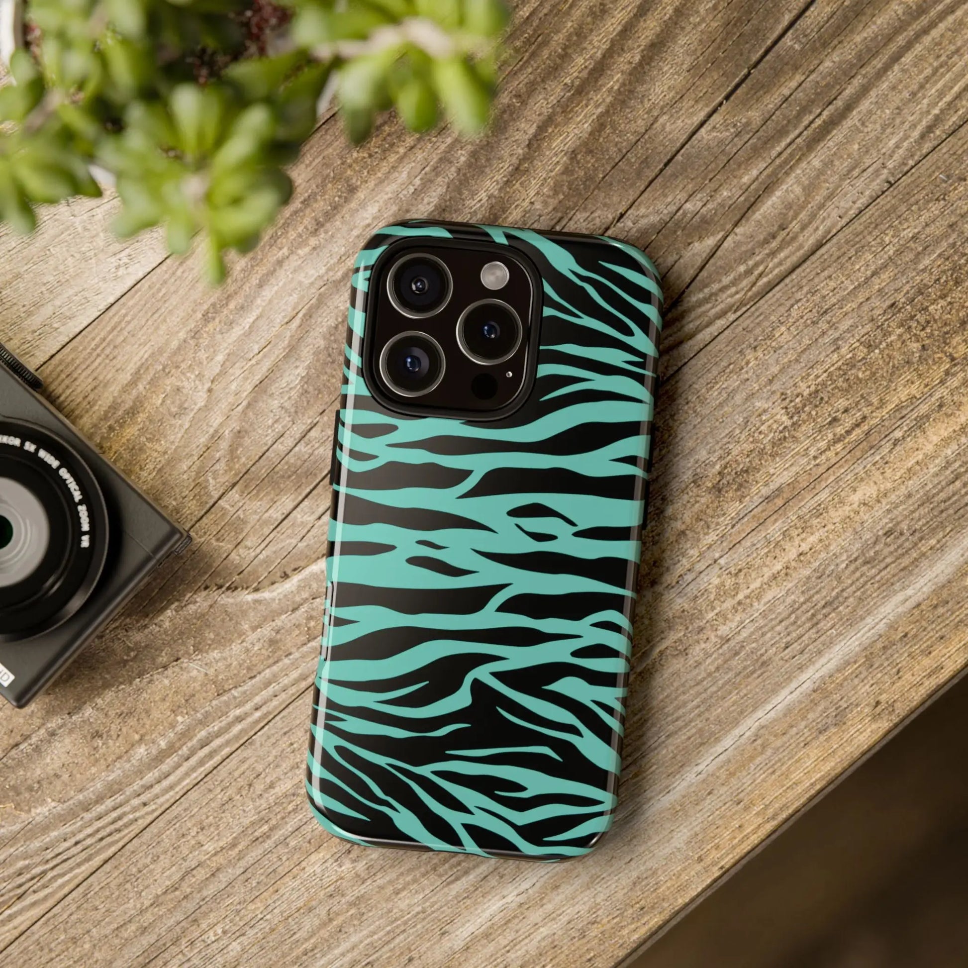 Back of a sleek turquoise and black zebra-striped glossy phone case with wild tiger print pattern for iphone 13 pro