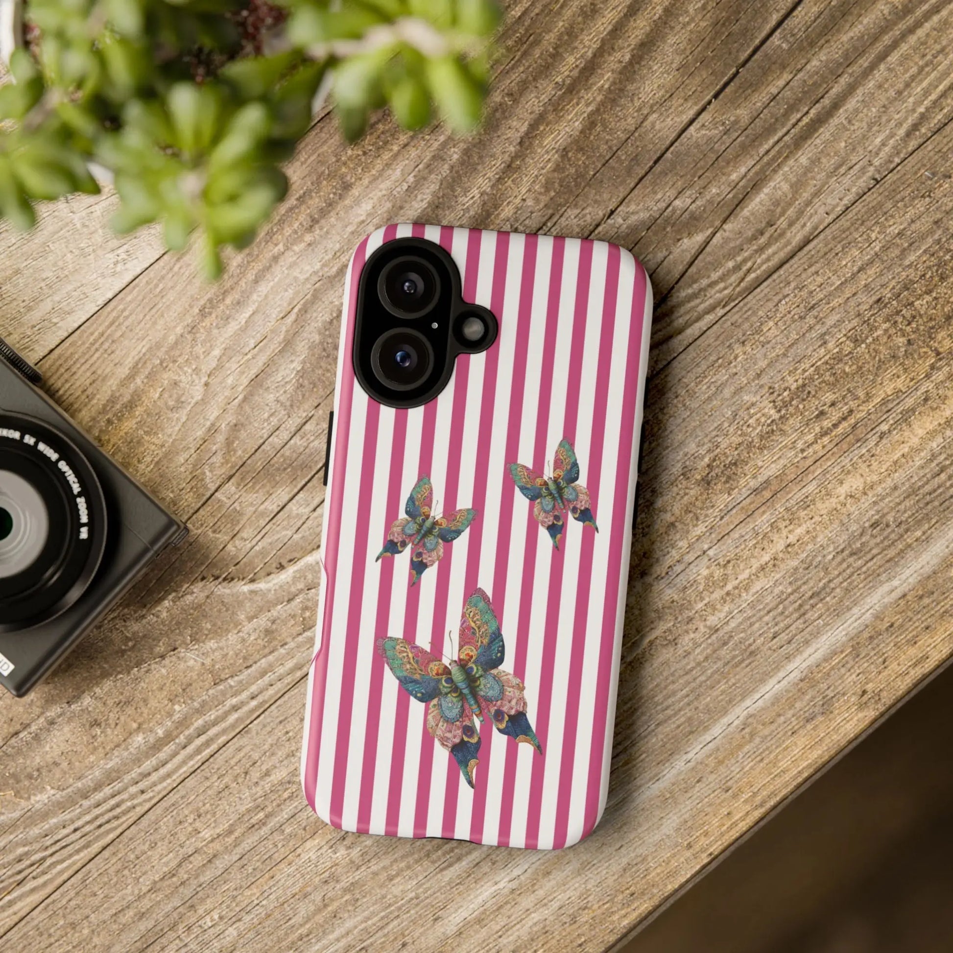 Back side of a floral butterfly pink stripe phone case featuring colorful butterflies on a pink and white striped design