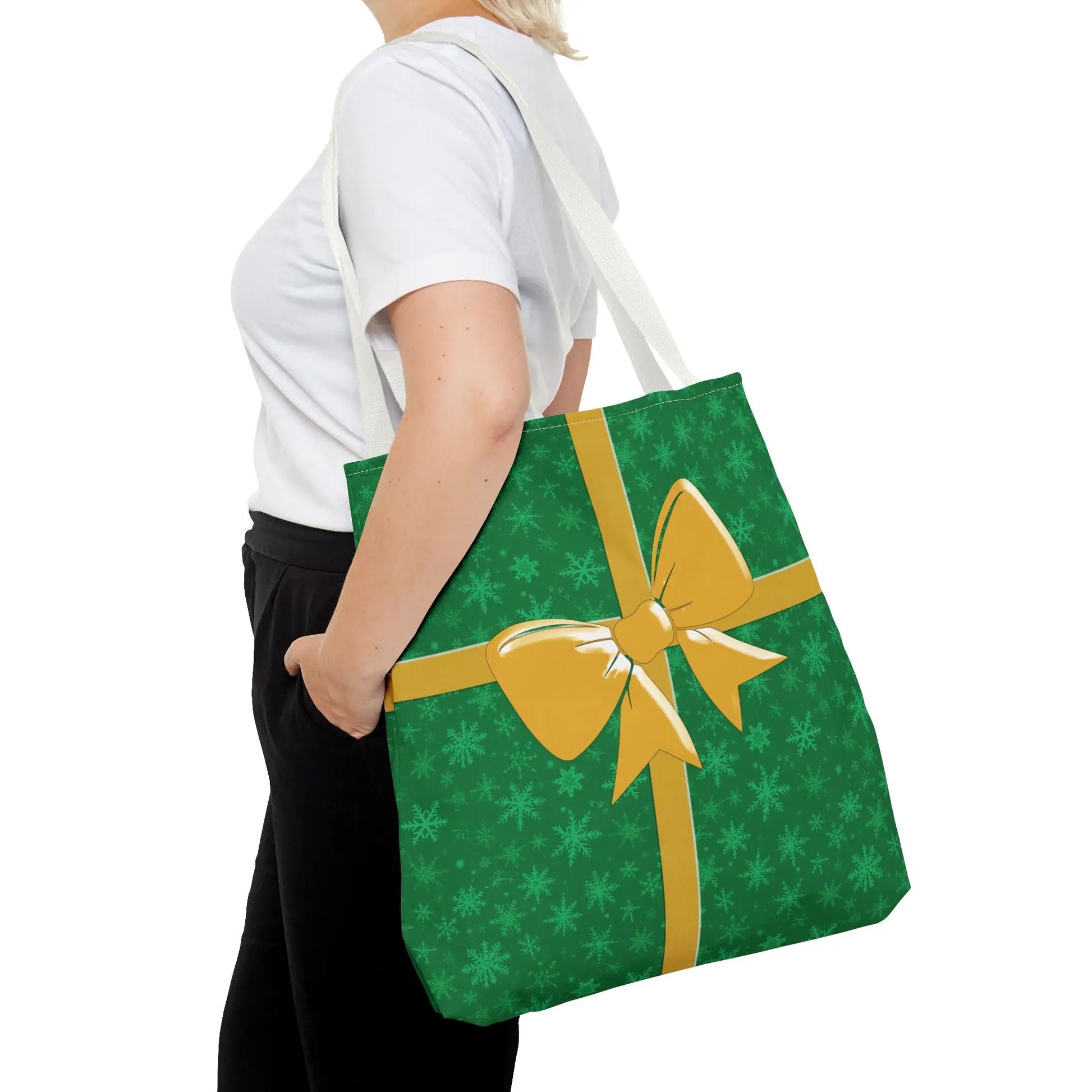 Green christmas tote bag featuring eco-friendly reusable material with a gold bow and subtle snowflake patterns for festive holiday shopping