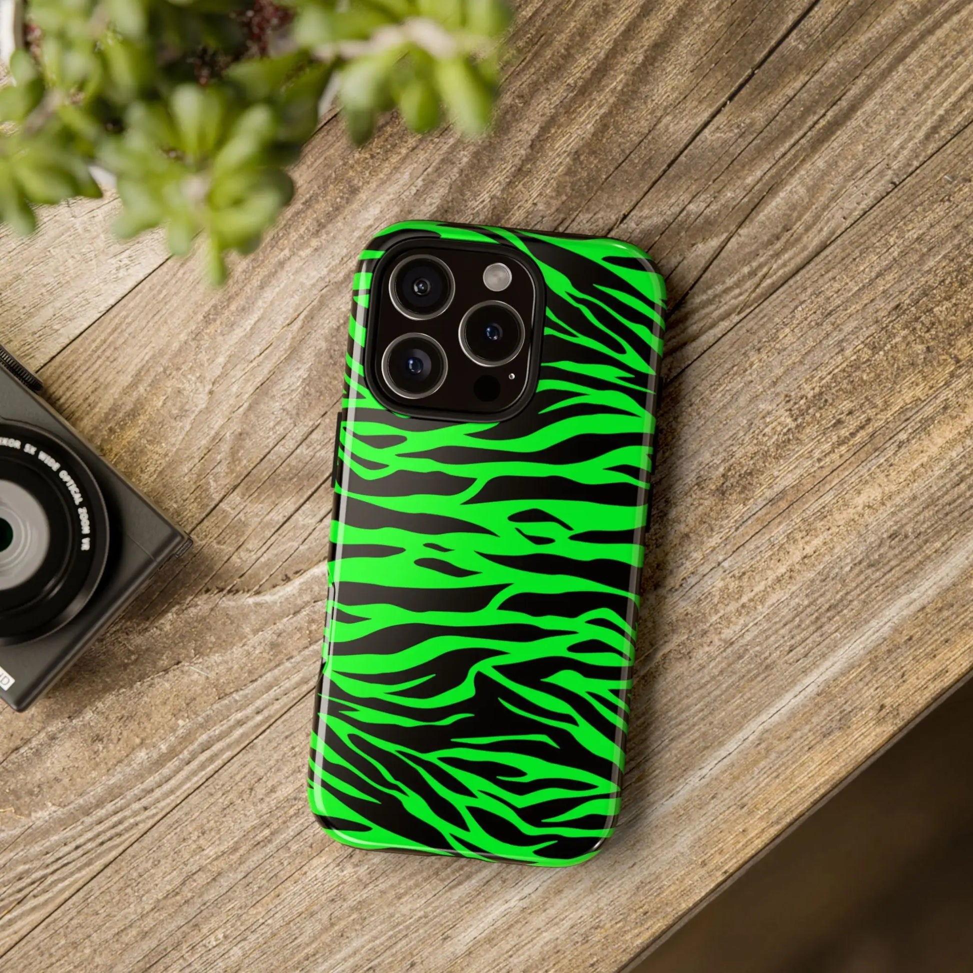 Back side of a vibrant neon green wild print tiger pattern phone case with black zebra stripes for iphone galaxy s and pixel phones