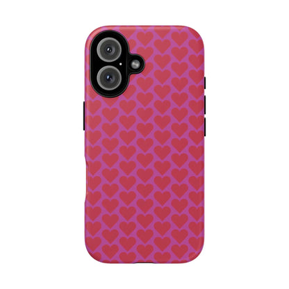 Vibrant pink heart pattern tough phone case with repeating red hearts on the back for romantic protection