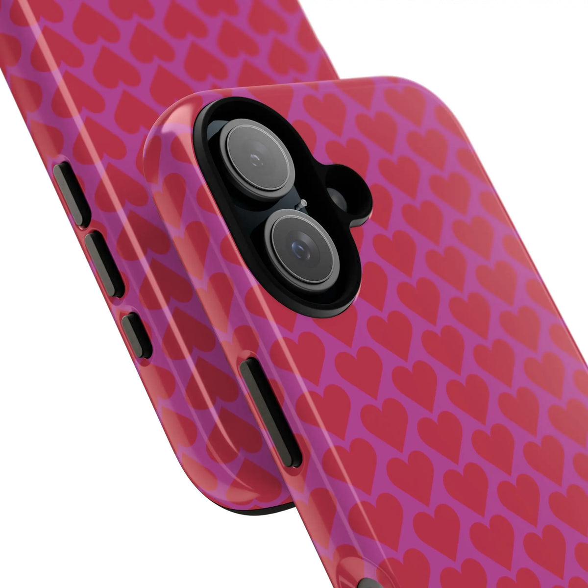 Back side of a glossy pink heart pattern tough phone case with a repeating red hearts design for romantic protection
