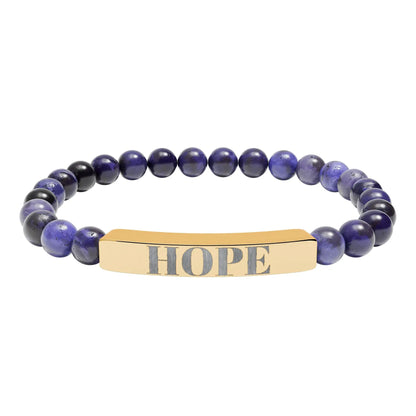 Gold-toned rectangular hope engraved natural stone bar with blue and black round beads in a stretch bracelet