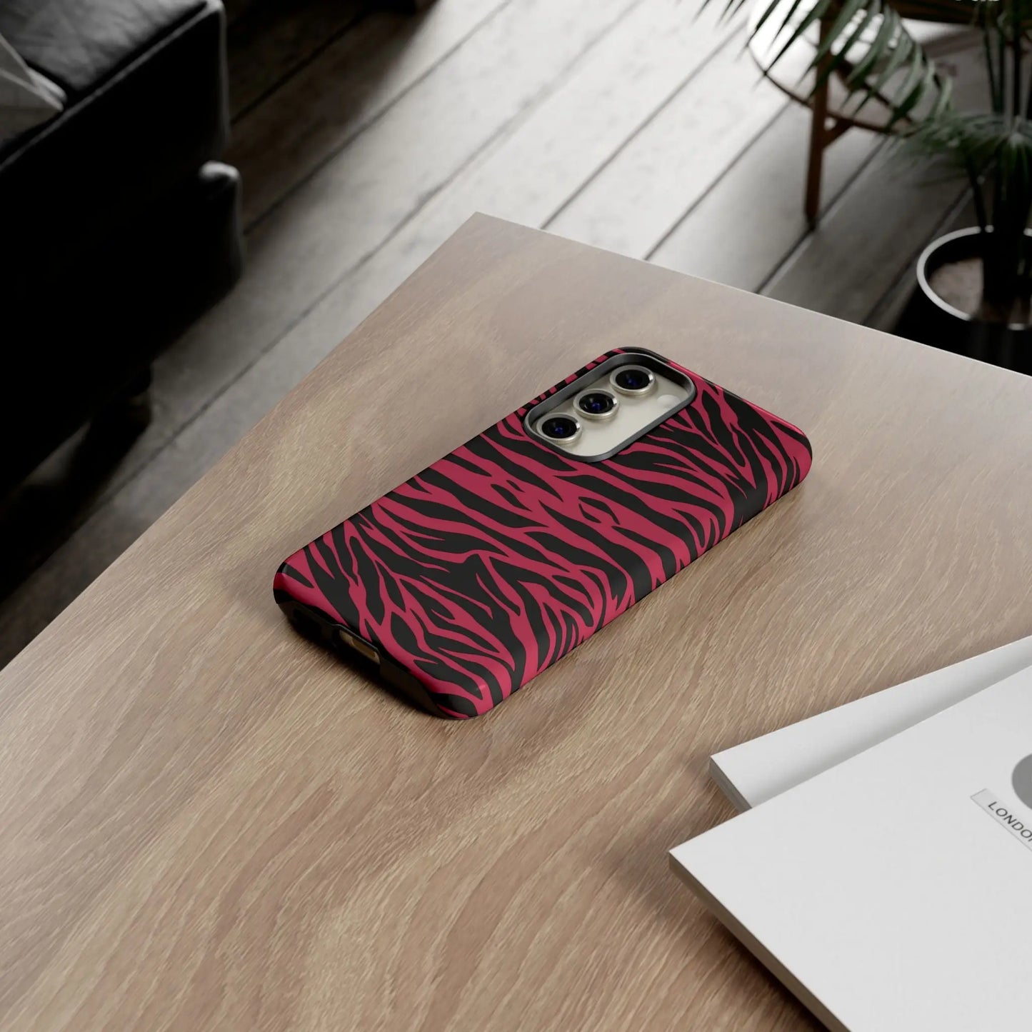 Back of a vibrant pink and black phone case with a sleek magenta wild tiger pattern print design