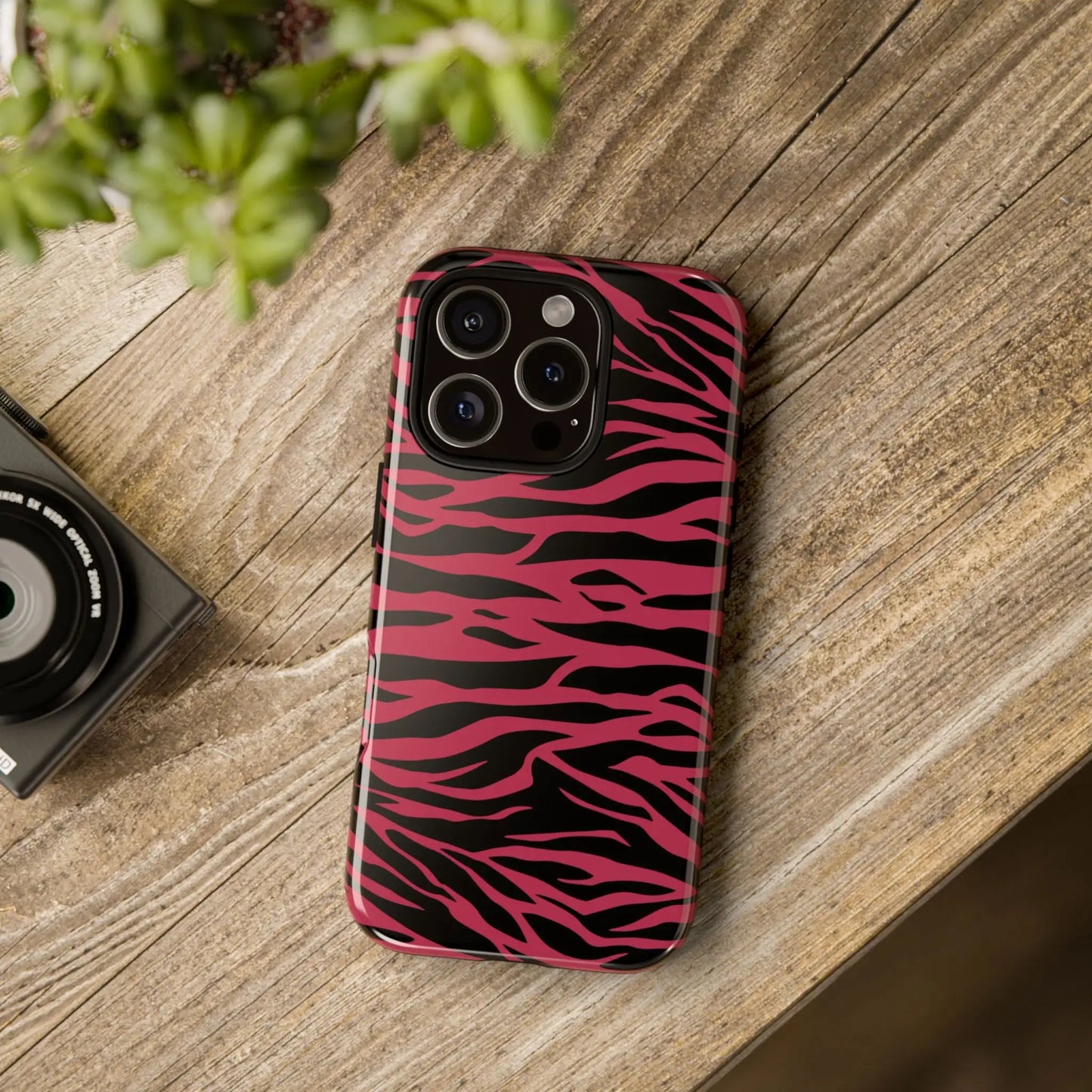 Vibrant pink and black glossy iphone 13 pro case featuring a magenta wild tiger pattern print on the back side