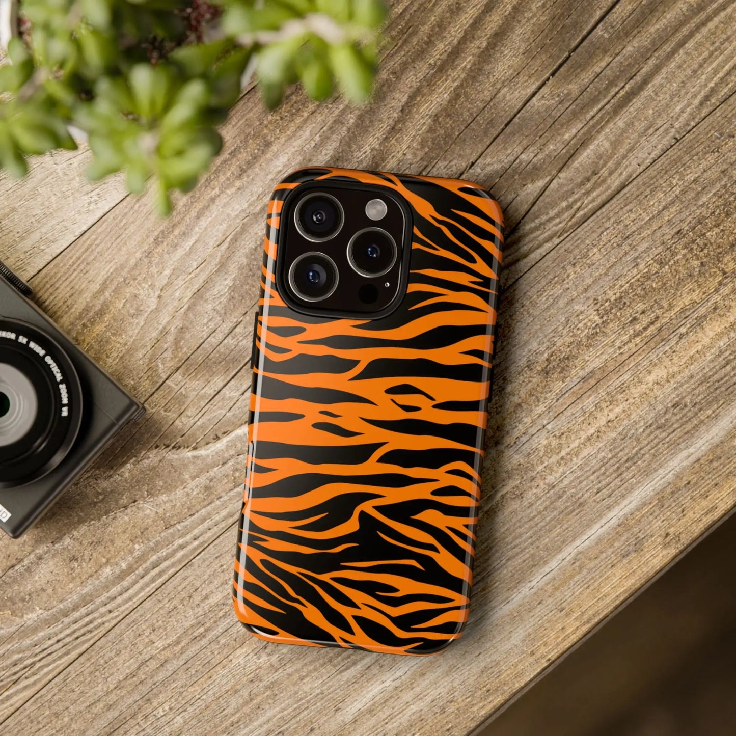 Back side of vibrant orange tiger print phone case with bold glossy tiger stripe pattern for iPhone Galaxy and Pixel phones