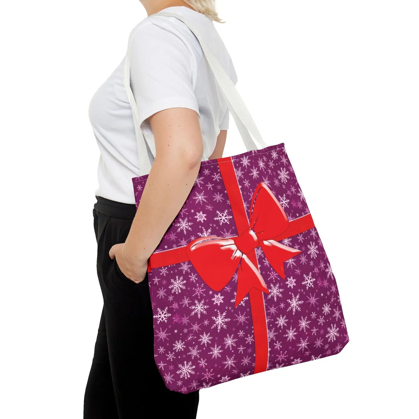 Purple gift-wrapped christmas tote bag with white snowflake pattern and red bow for festive pink christmas use