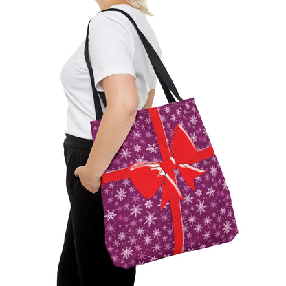 Purple gift-wrapped pink christmas tote bag with white snowflakes and red bow for festive holiday shopping carryall