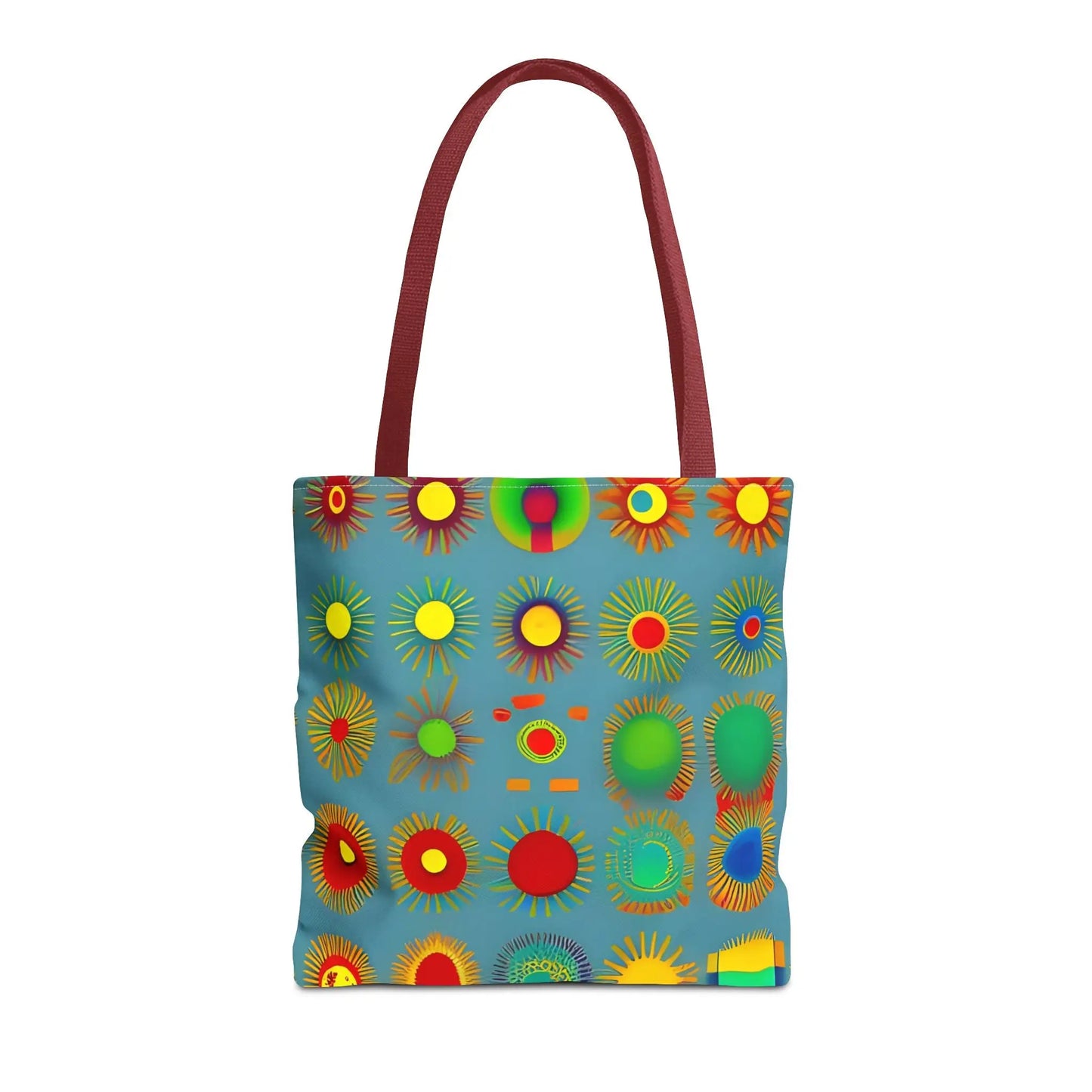 Sun pattern tote bag in vibrant blue with bold colorful circular patterns and contrasting maroon handles
