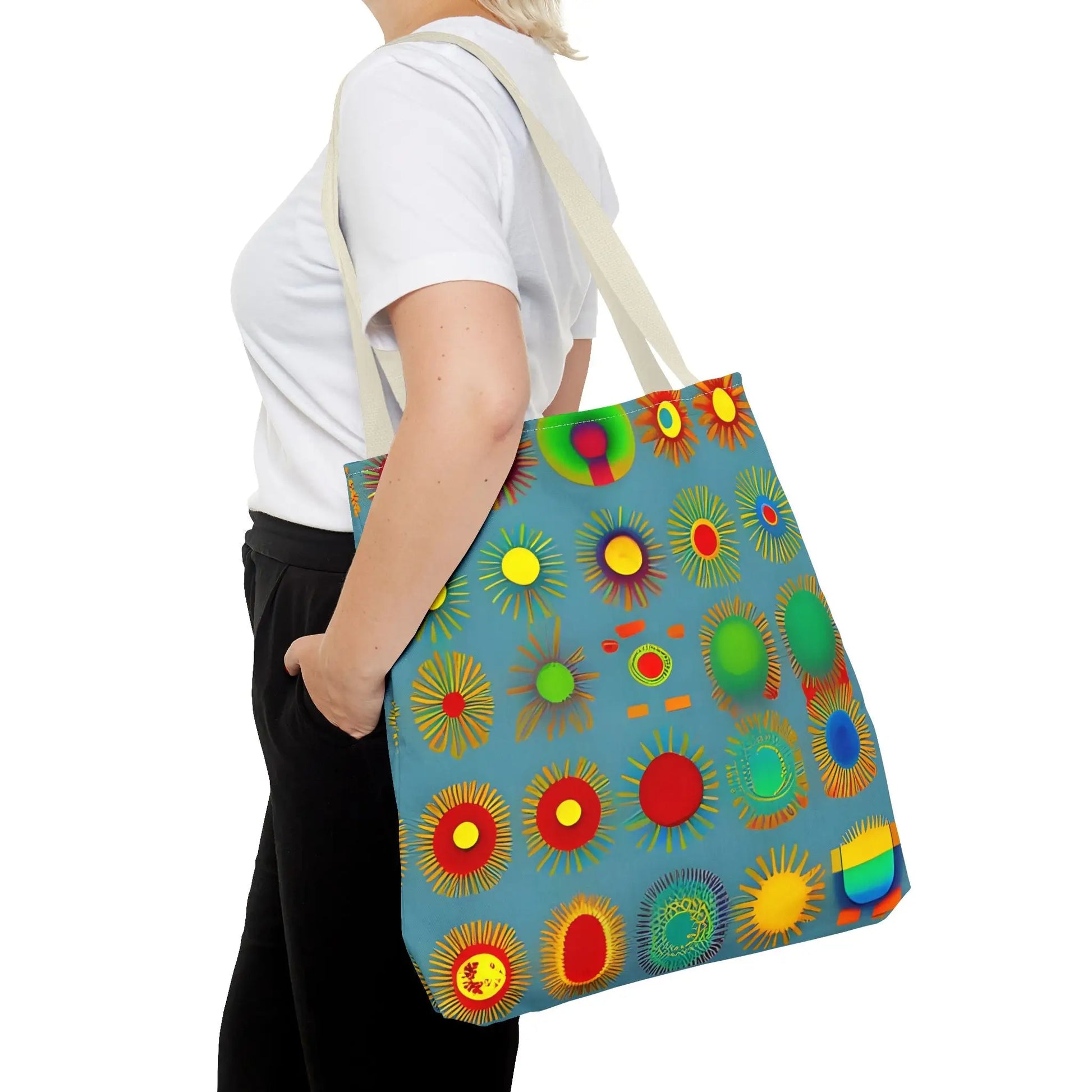 A vibrant blue canvas sun pattern tote bag featuring colorful sunburst circles in red yellow green and orange
