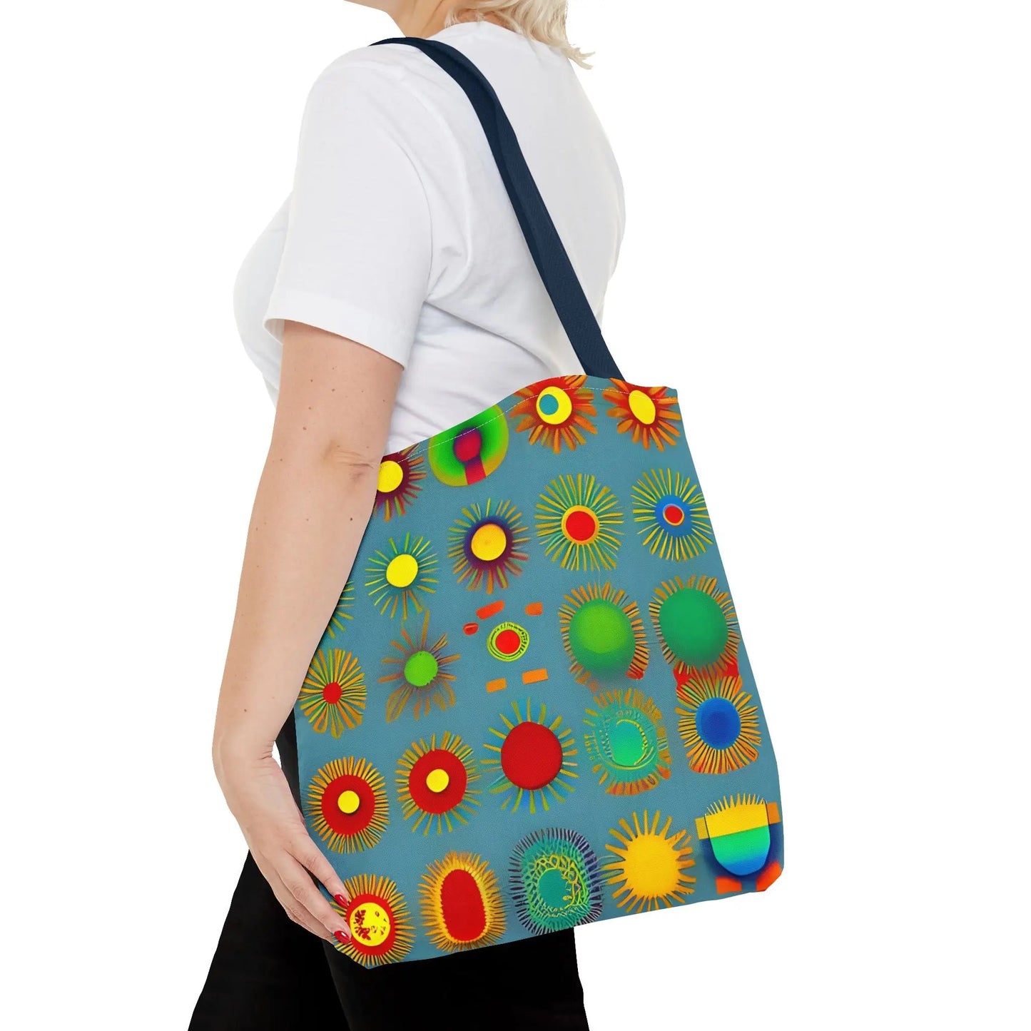 A vibrant blue canvas sun pattern tote bag with colorful sunburst circles in red yellow green and orange