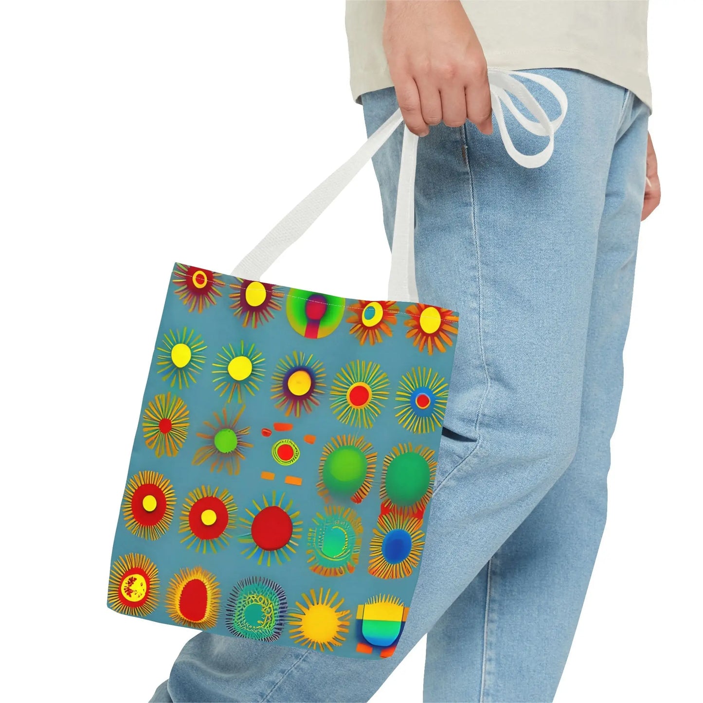 A vibrant blue sun pattern tote bag featuring colorful sunburst circles and white handles in a pattern tote bag design