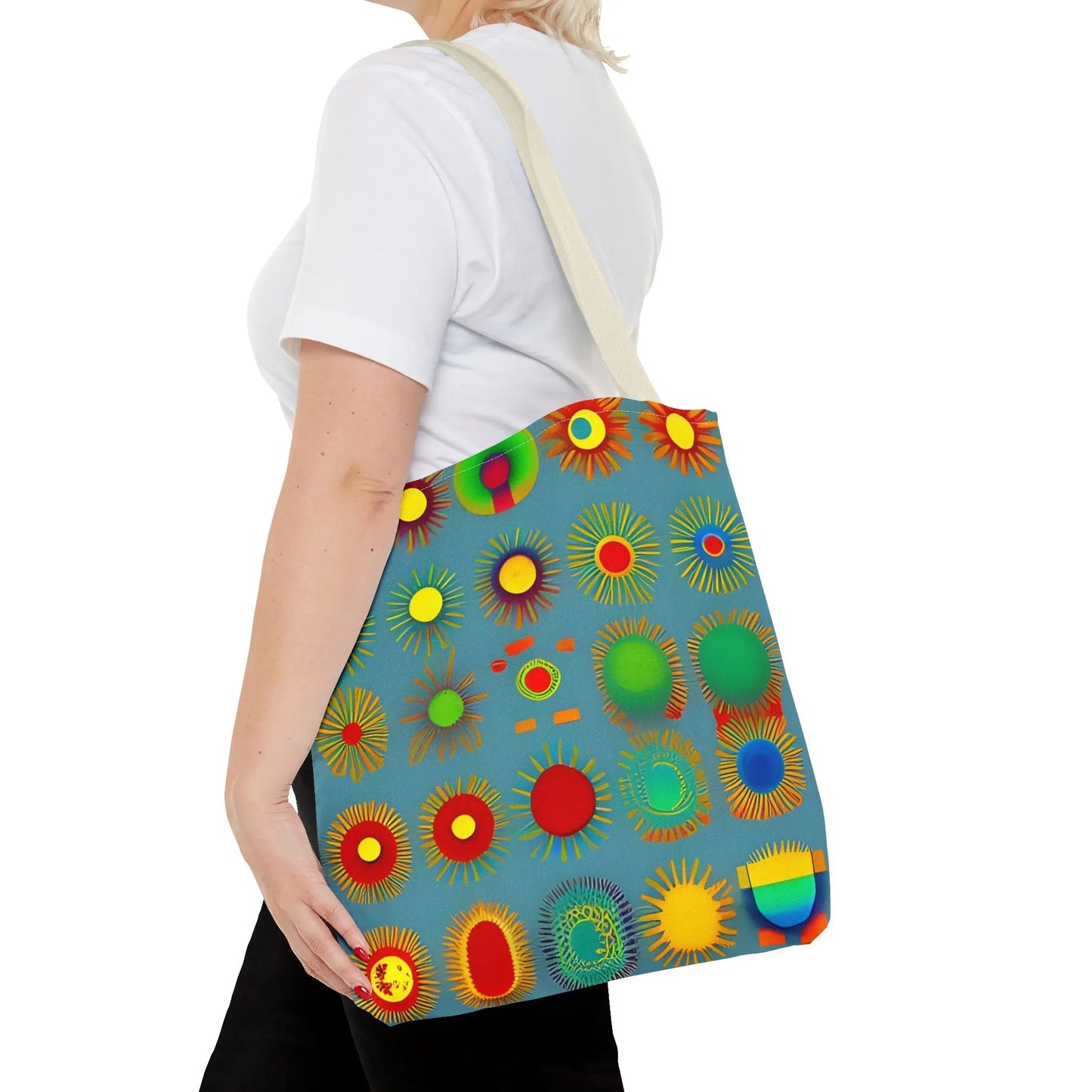 A vibrant blue sun pattern tote bag with colorful sunburst circles in red green yellow and orange on canvas material