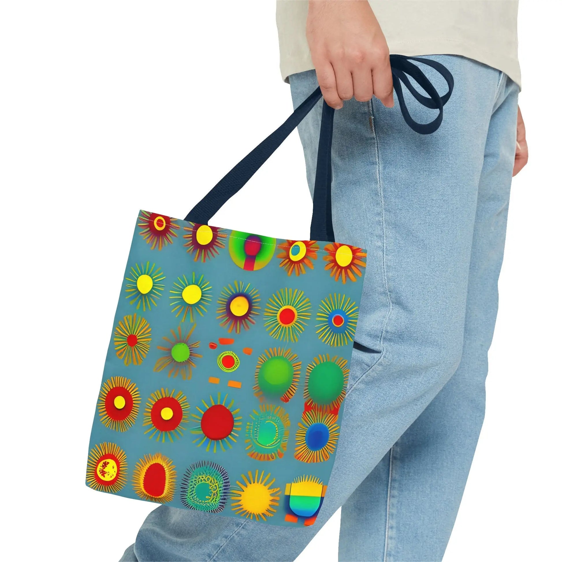 A vibrant blue sun pattern tote bag with colorful sunburst circles and black handles perfect for everyday use