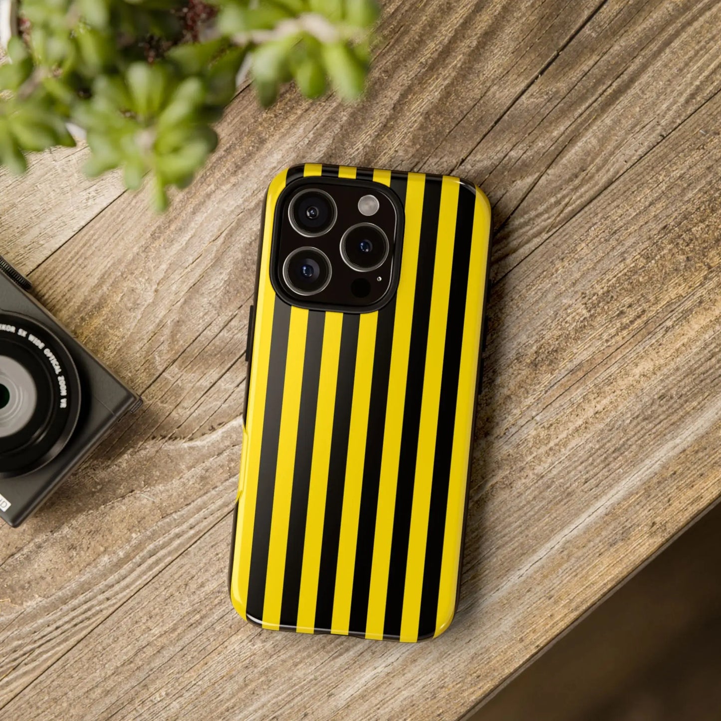 A sleek yellow and black stripe tough case phone case shown from the back for modern iphone models