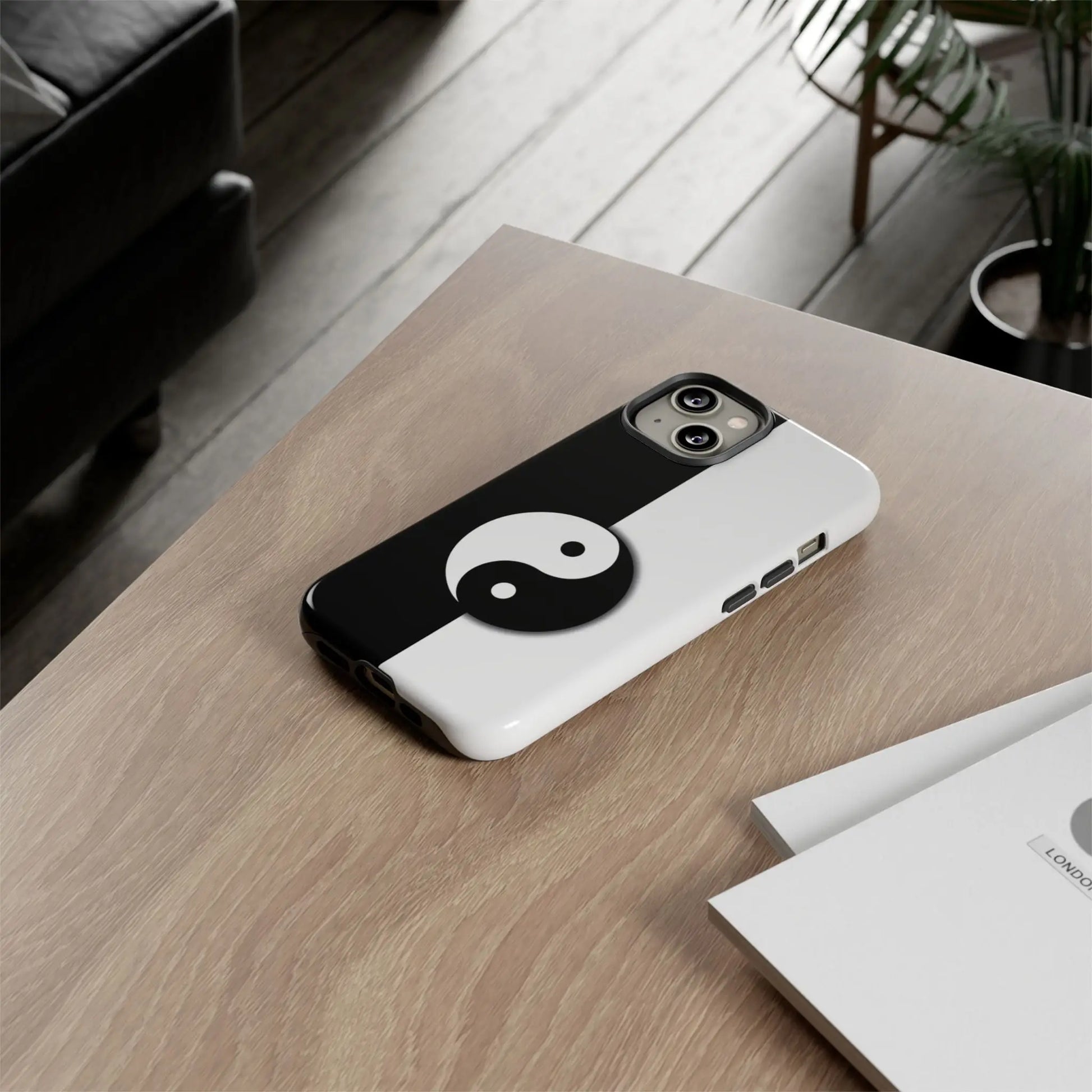 Back side of a glossy tough yin yang black and white phone case featuring the classic yin yang design